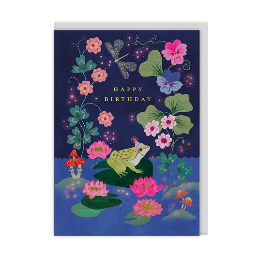 Greeting card with a frog, flowers, and 'Happy Birthday' text on a dark blue background