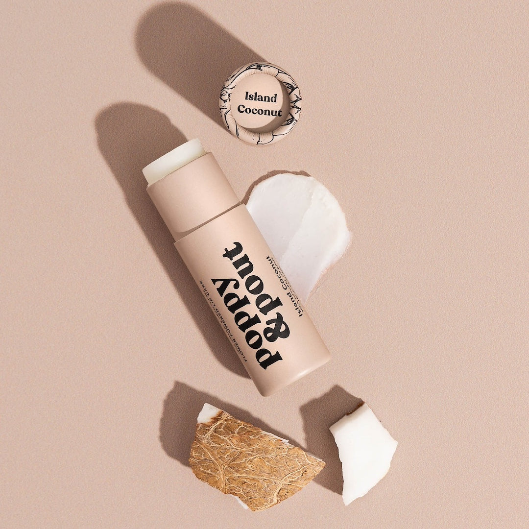 Tube of Lip Balm from Poppy & Pout in the scent Island Coconut on a neutral background