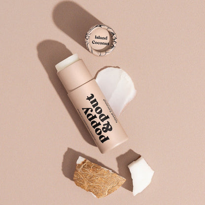 Tube of Lip Balm from Poppy & Pout in the scent Island Coconut on a neutral background