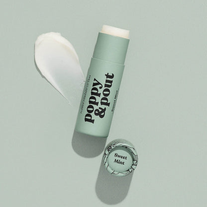 Tube of Lip Balm from Poppy & Pout in the scent Sweet Mint on a blue background