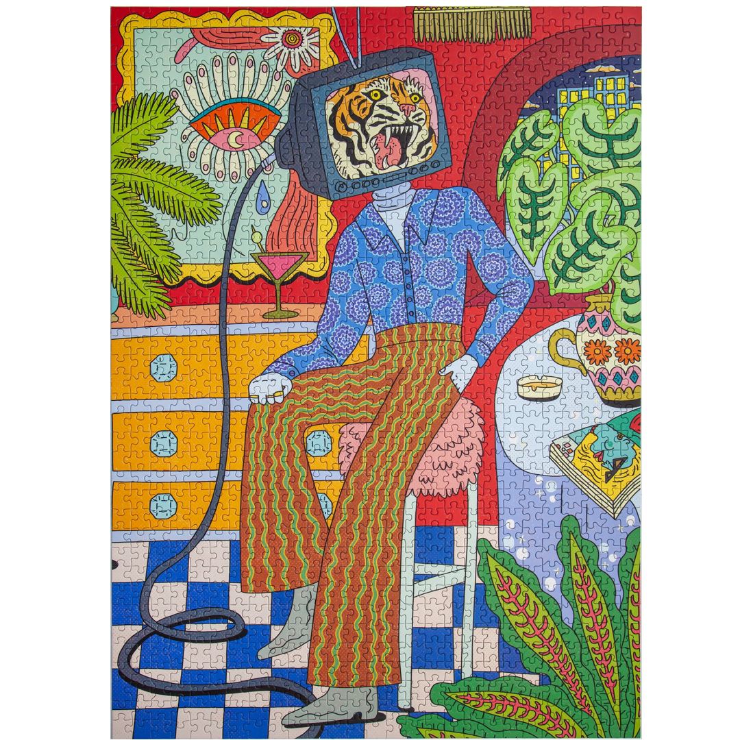 A colorful jigsaw puzzle featuring a surreal illustration of a seated person with a television head showing a tiger, surrounded by plants, furniture, and patterned details in bright red, blue, green, yellow, and orange tones.