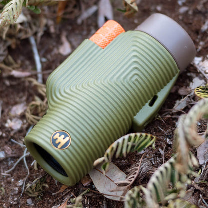 Green monocular on the forest floor