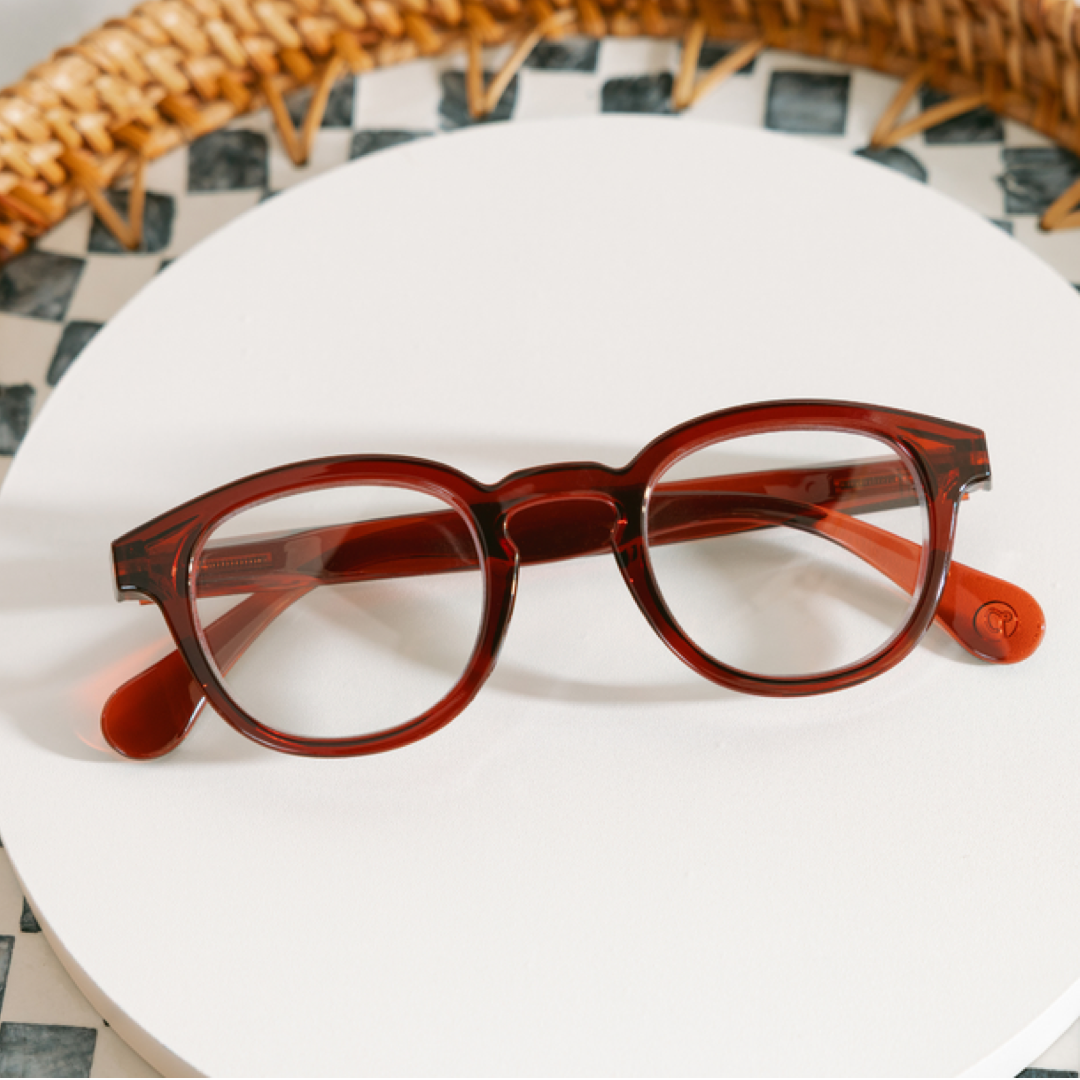 cranberry red eyeglasses on a white background