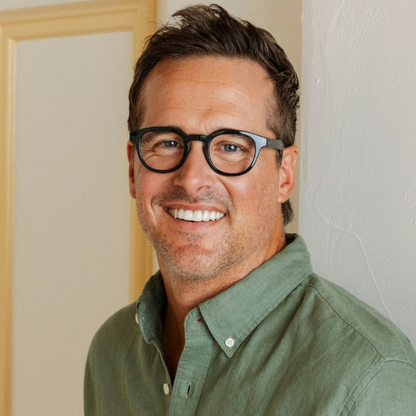 Man wearing glasses and a green shirt indoors
