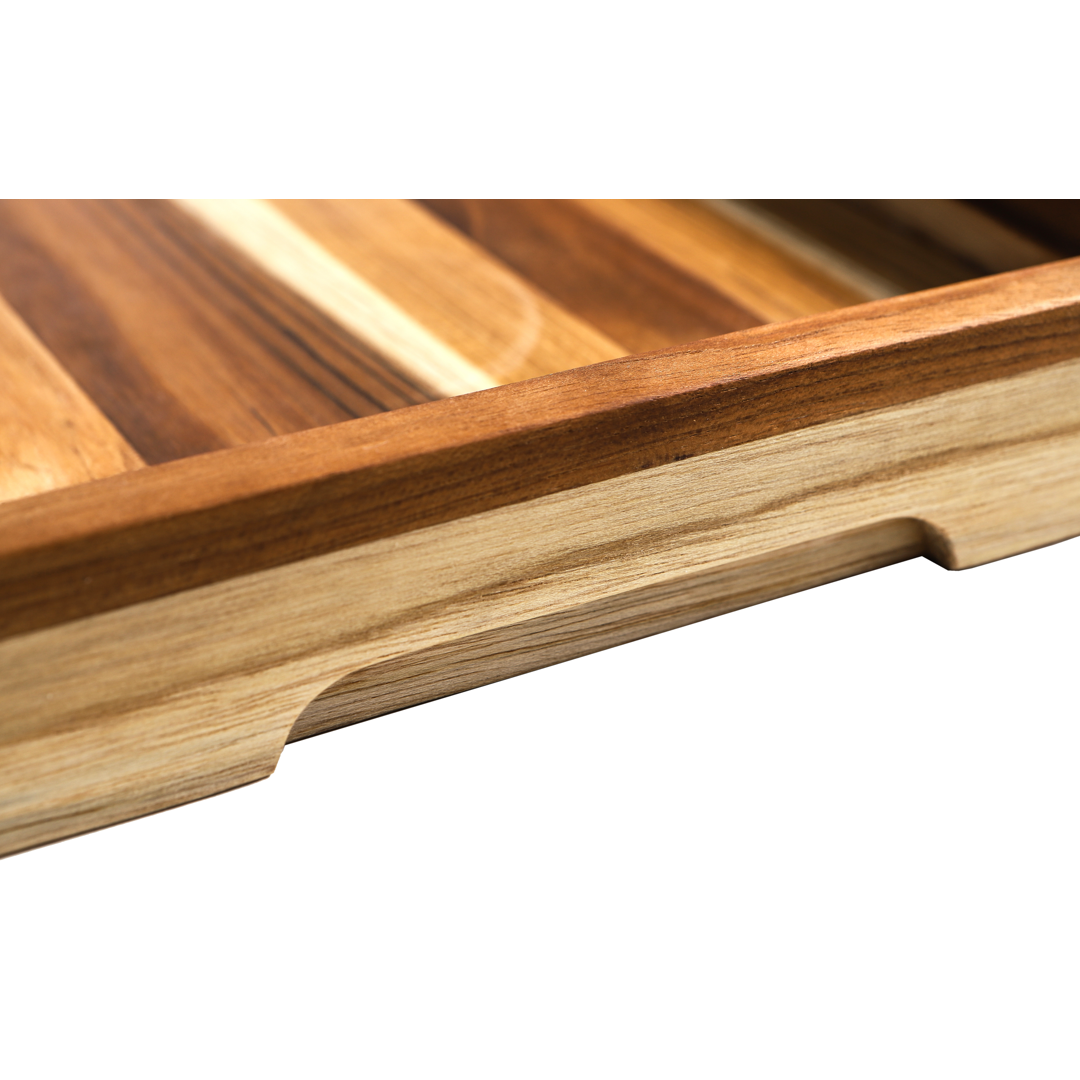 Close-up of a wooden cutting board with slotted design on a white background