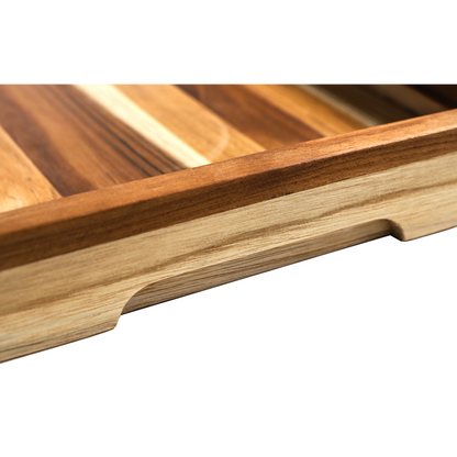 Close-up of a wooden cutting board with slotted design on a white background
