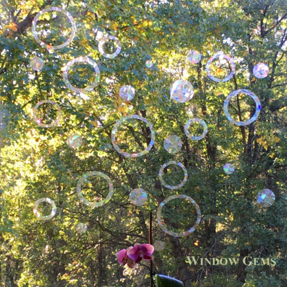 Iridescent rings and circles window decorations on a window
