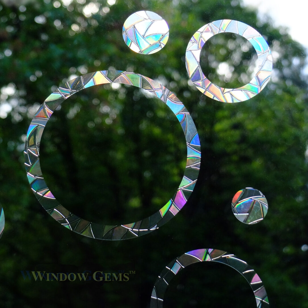 window with iridescent ring and circles stickers on it