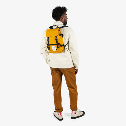 Person wearing a yellow backpack on a white background