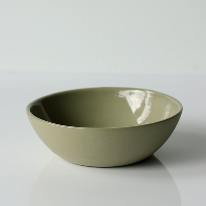 Sage green ceramic bowl on a white background
