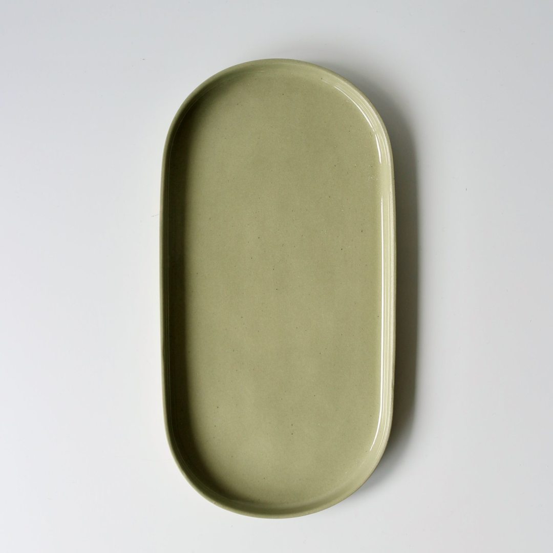 Sage green oval ceramic tray on a white background