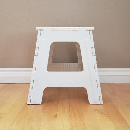 White step stool on a wooden floor.