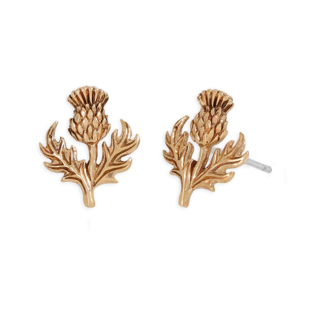 Gold thistle-shaped earrings on a white background