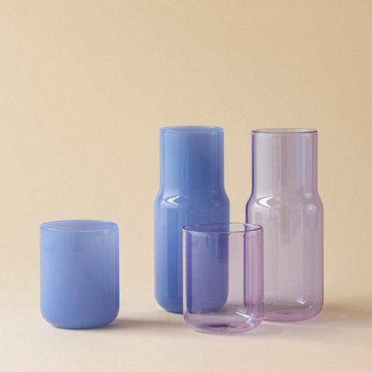 2 carafes with matching tumblers on a neutral background