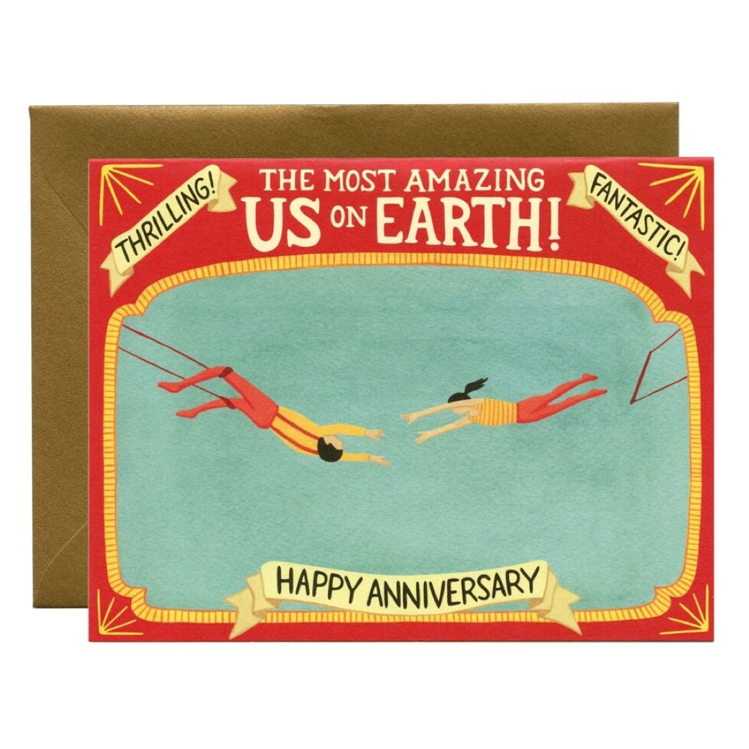 Anniversary card with two people parasailing and celebratory text that reads the most amazing us on earth happy anniversary on a red border.