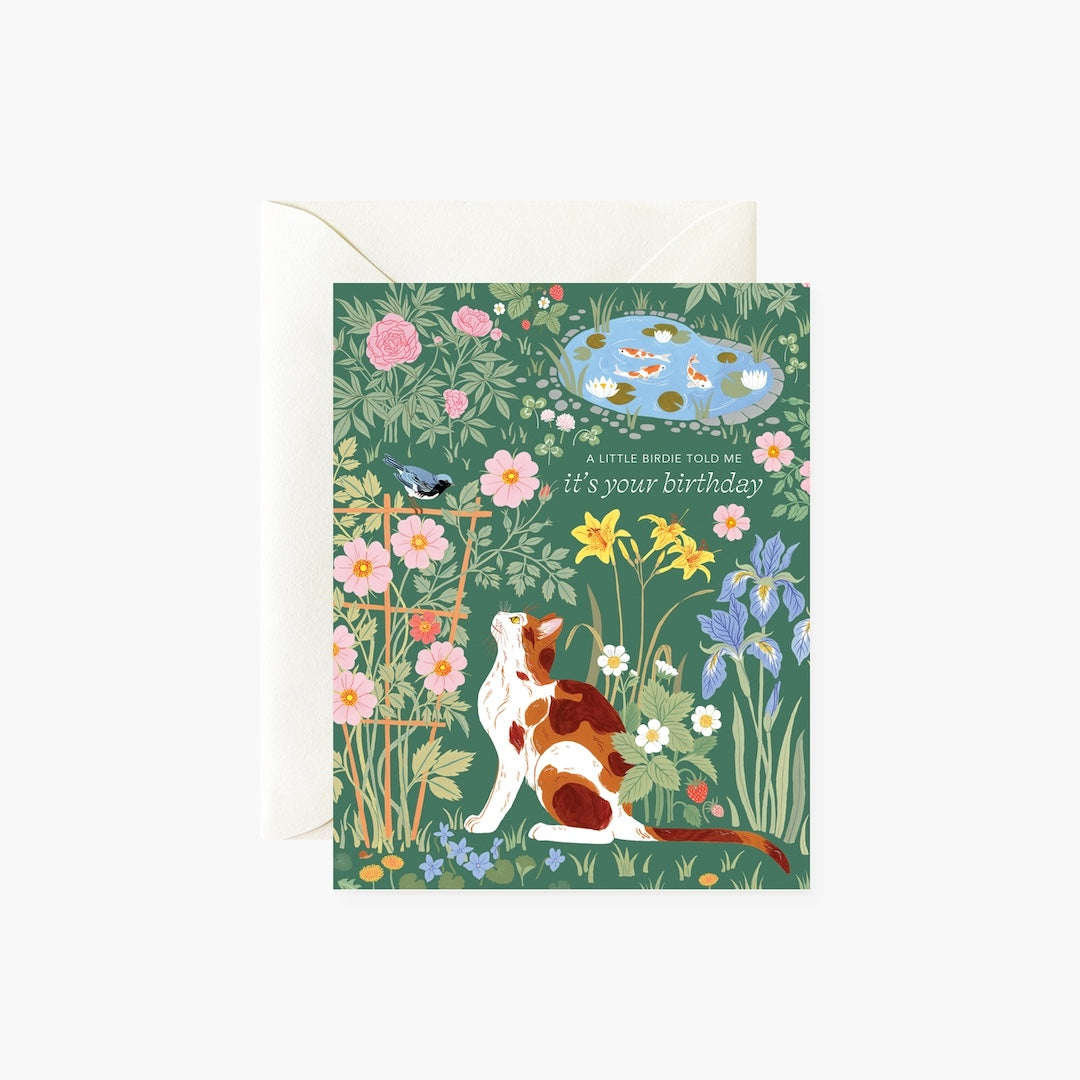 Greeting card with a cat, bird, and nature illustration on a green background. There's text that reads "a little birdie told me it's your birthday"