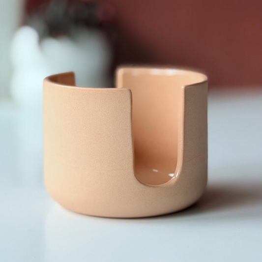 Light pink/apricot colored ceramic sponge holder