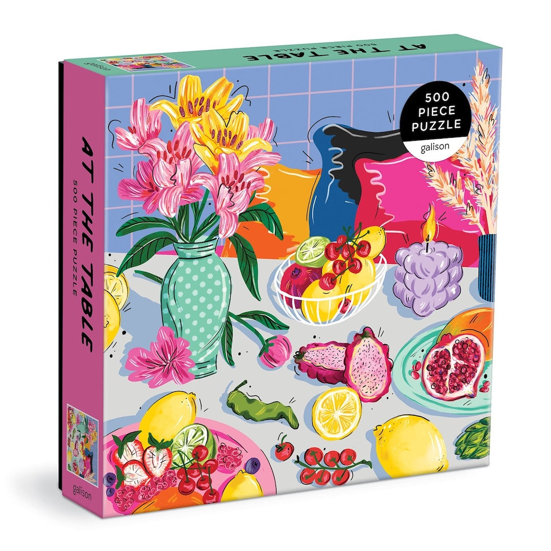 Jigsaw puzzle box with colorful design of fruits, flowers, and tableware on a white background