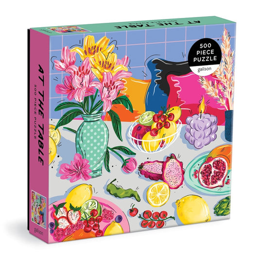 Jigsaw puzzle box with colorful design of fruits, flowers, and tableware on a white background