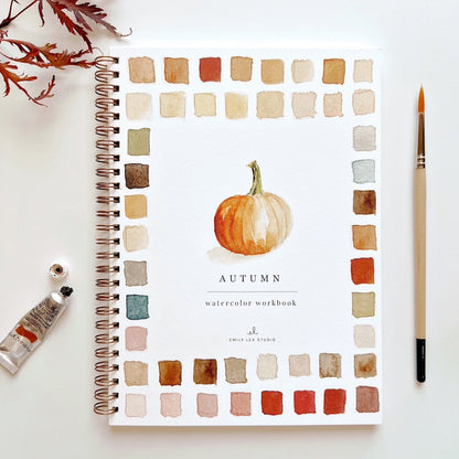 Autumn-themed watercolor workbook with a pumpkin illustration on a white background.
