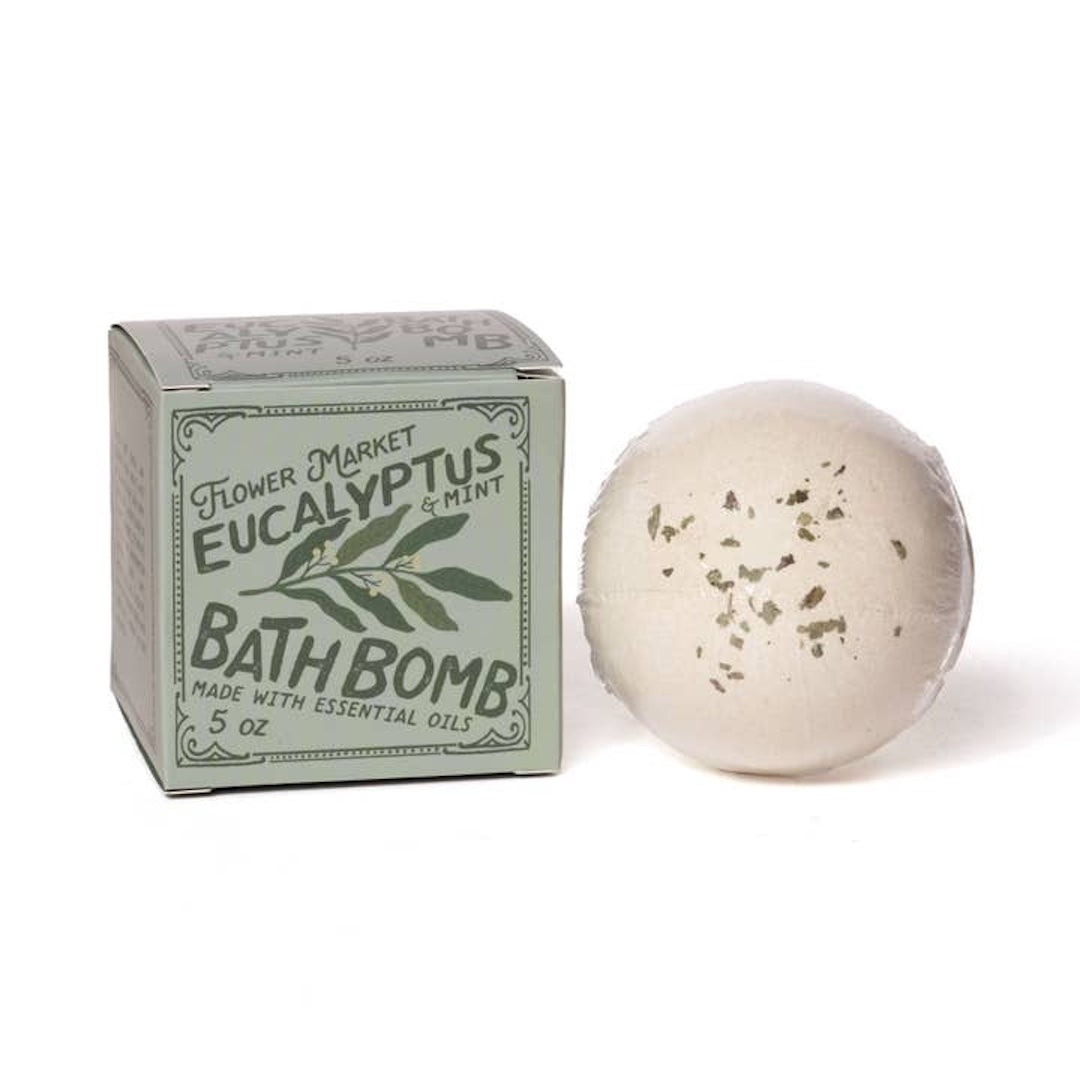 Bath bomb with packaging labeled 'Eucalyptus & Mint' on a white background