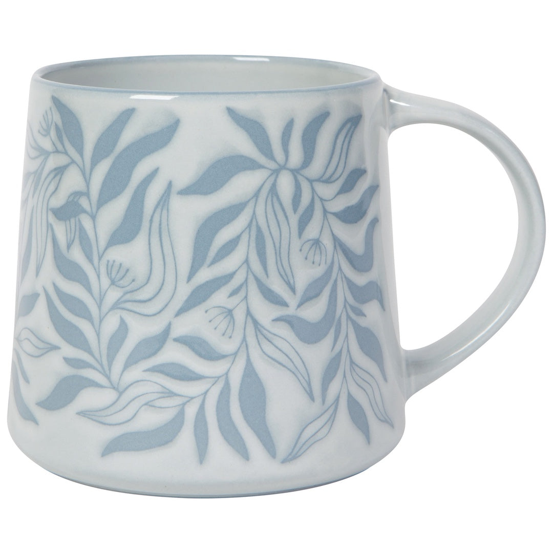 White mug with blue leaf pattern on a white background