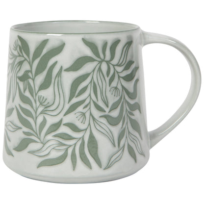 White mug with green leaf pattern on a white background