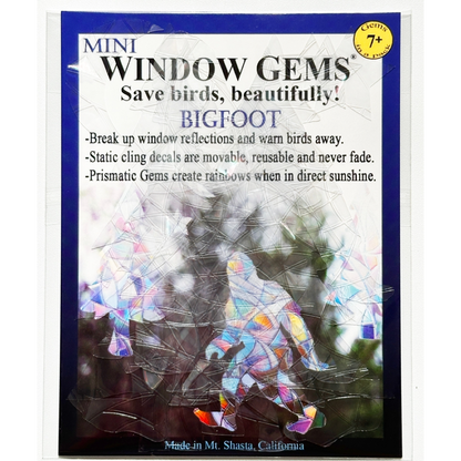 Pack of Mini Window Gems Bigfoot decals, featuring a package insert with text and a preview of the iridescent, rainbow-reflective crystal-like decals applied over a window.
