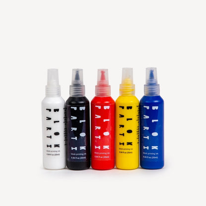 5 different paint bottles including white, black, red, yellow, and blue