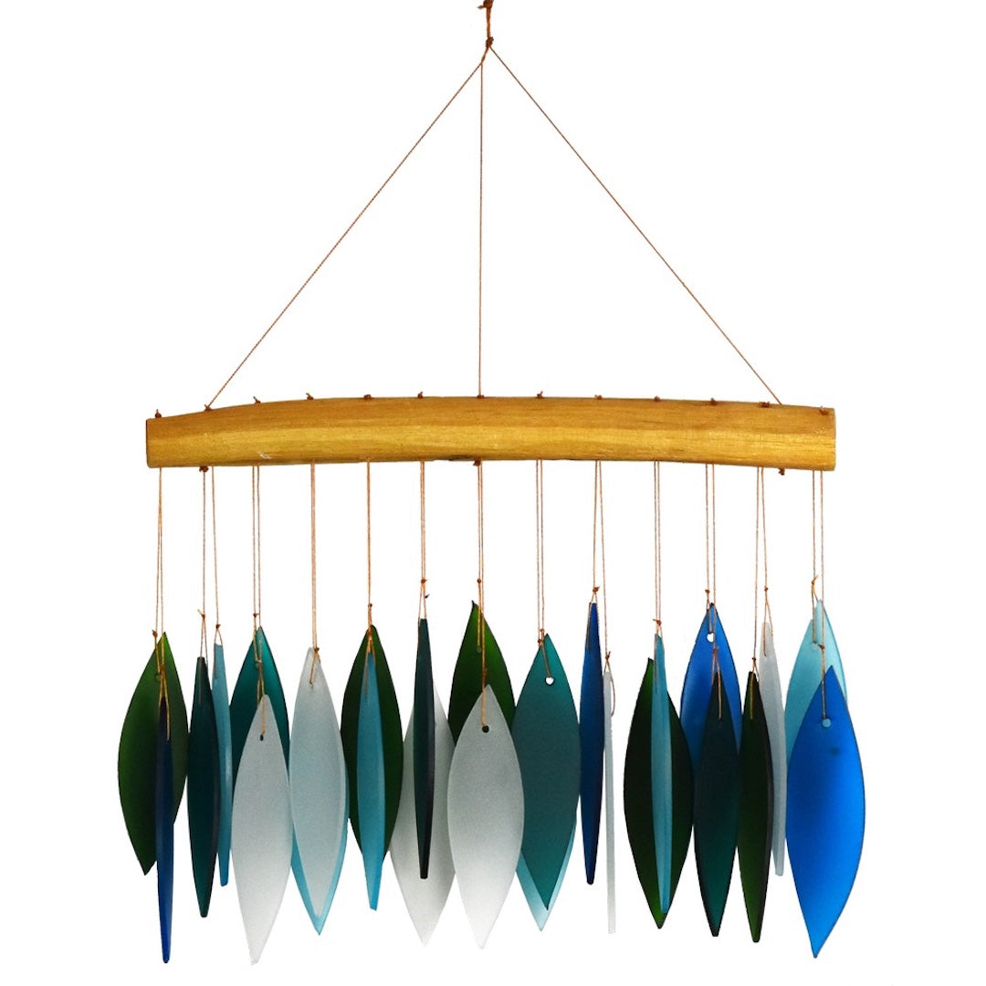 wind chime with blue and green pieces of glass hanging from a piece of driftwood