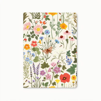Notebook with a white cover and a floral inspired pattern that features a moth, flowers, and leaves. In the center of the cover "Notes" is written in gold. Shown on a white background.