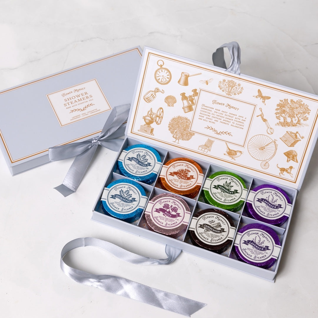 Set of shower steamers in a branded box on a white background