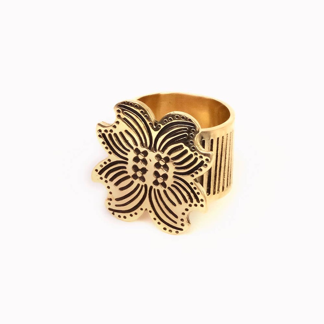 Brass floral bandana slide ring on a white background