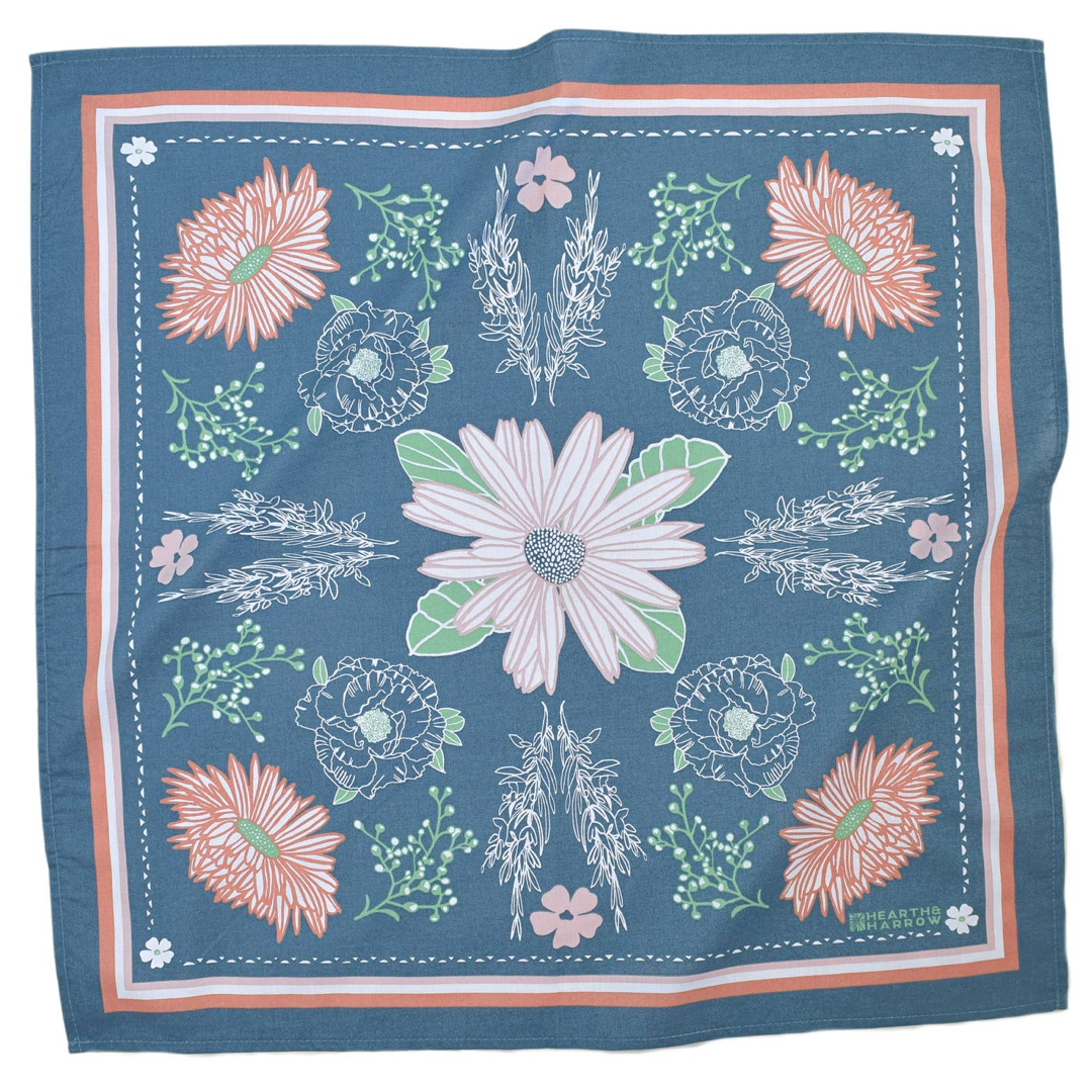 light blue bandana with a calendula blossom pattern on it