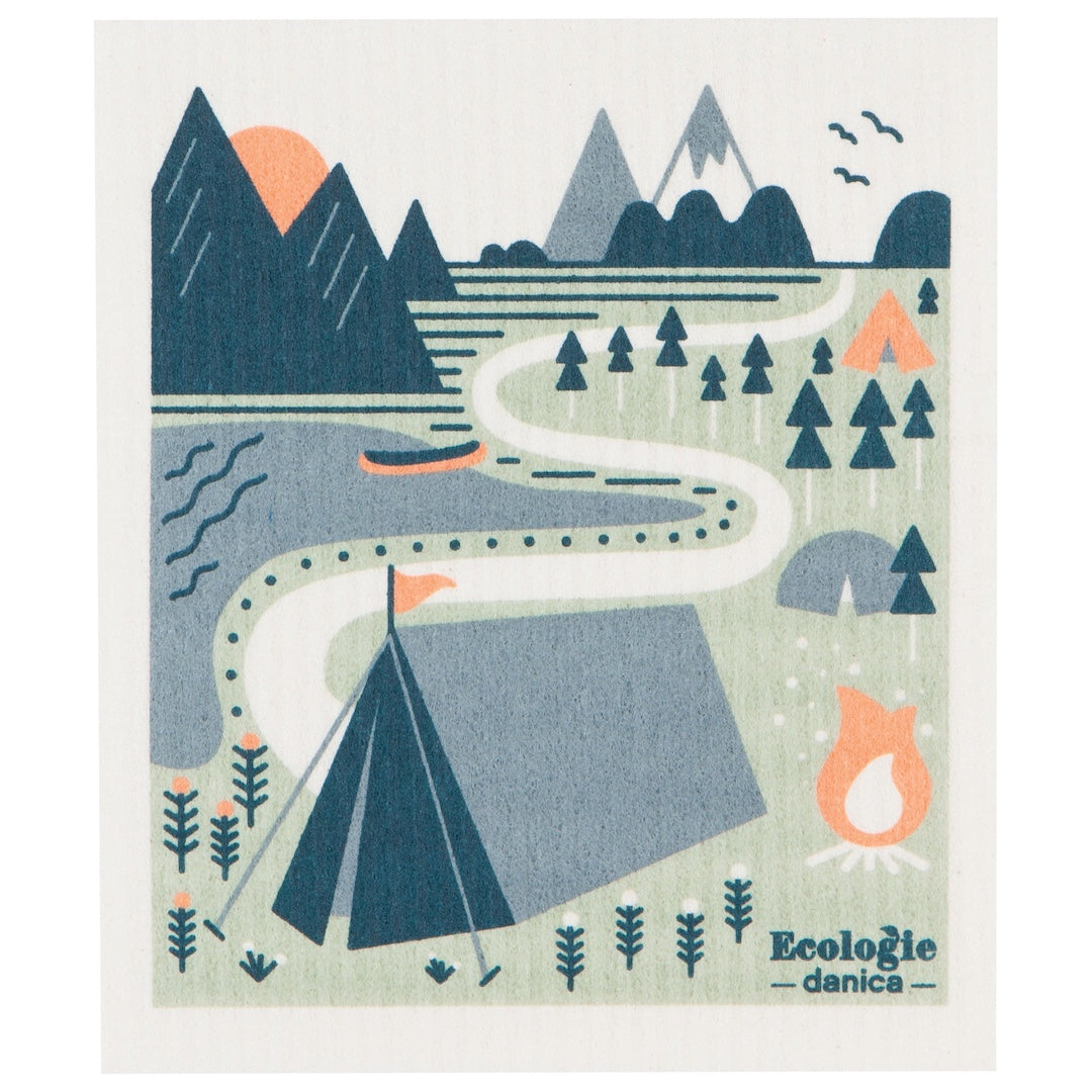 Swedish dishcloth with an Illustration of a camping scene with mountains, trees, and tents on it