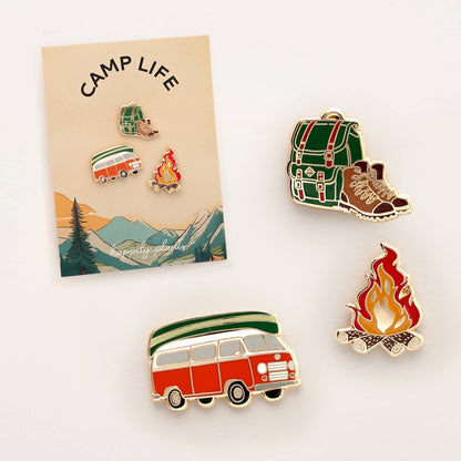 Set of camping-themed pins on a 'Camp Life' card with a scenic design.