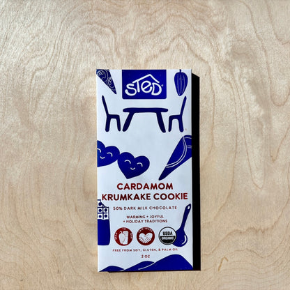 STED cardamom krumkake cookie chocolate bar  in packaging on a wooden surface