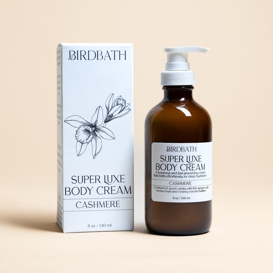 Birdbath Cashmere Super Luxe Body Cream bottle and packaging on a beige background