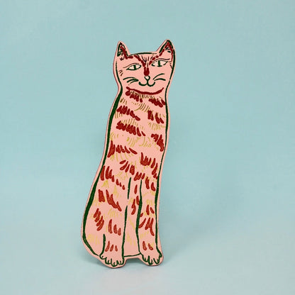 pink cat shaped leather bookmark on a light blue background