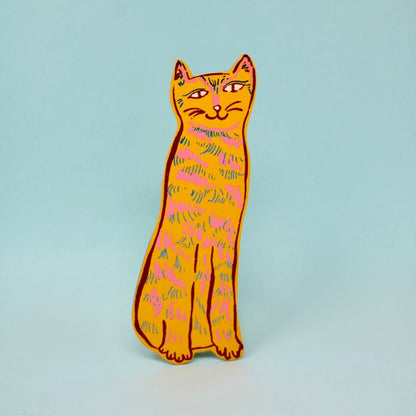 yellow cat shaped leather bookmark on a light blue background