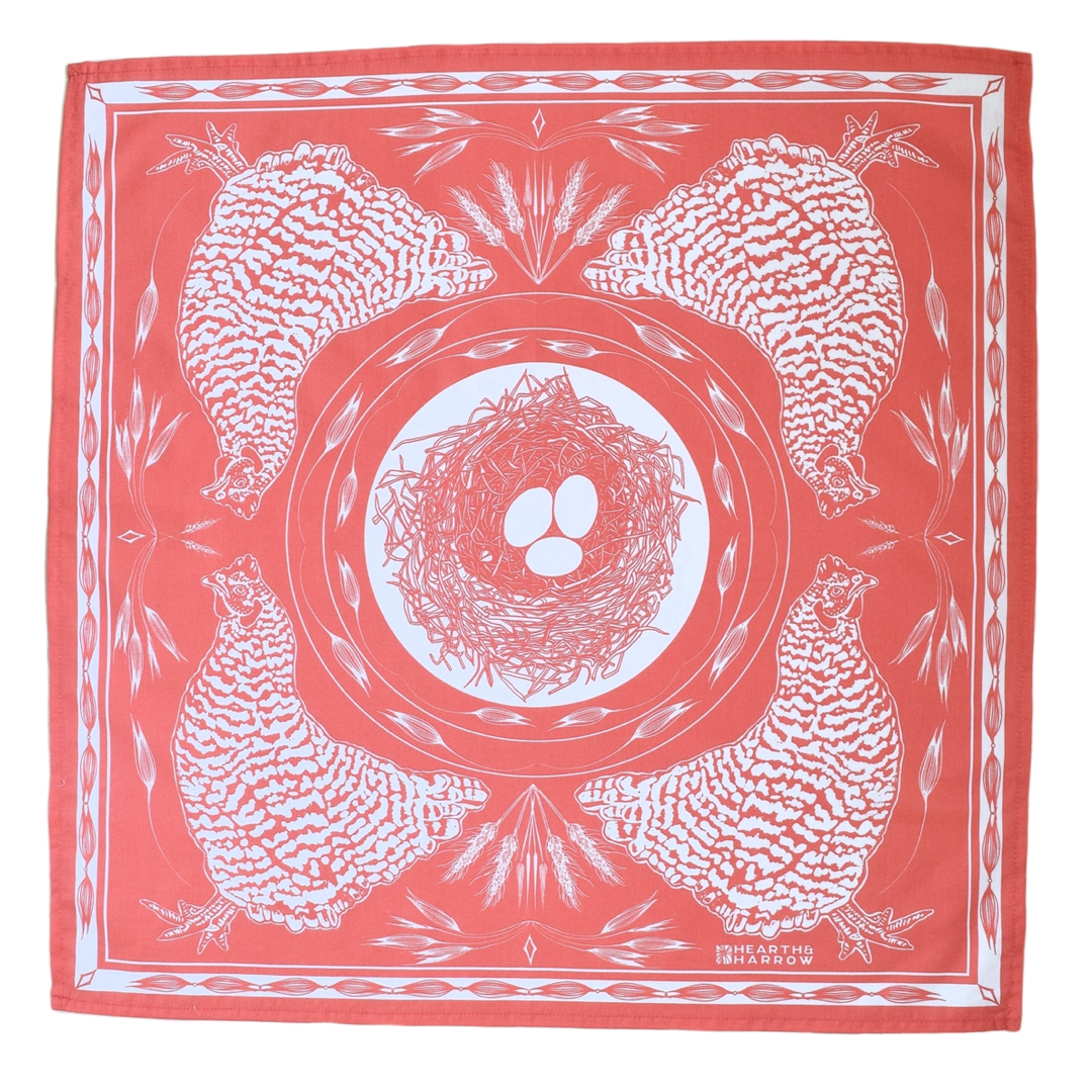A square coral-red silk scarf featuring a white graphic print of four chickens around a central nest with three eggs, shown flat against a white background.