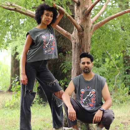 Two people wearing sleeveless graphic shirts in a natural setting