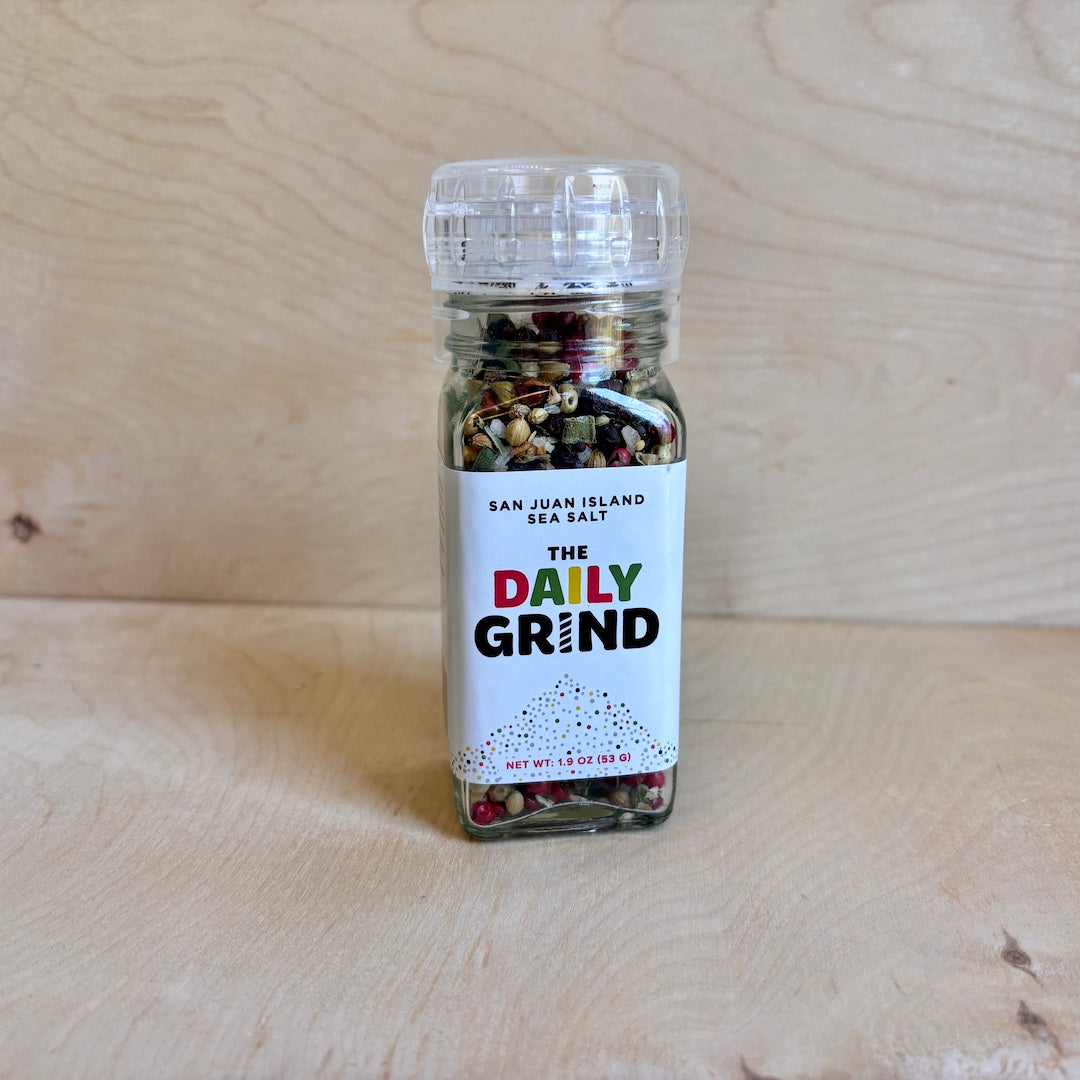 Spice jar labeled 'The Daily Grind' on a wooden surface