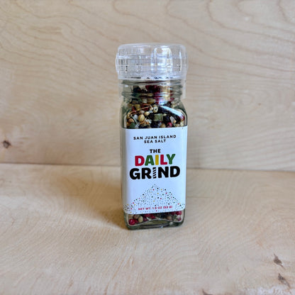 Spice jar labeled 'The Daily Grind' on a wooden surface