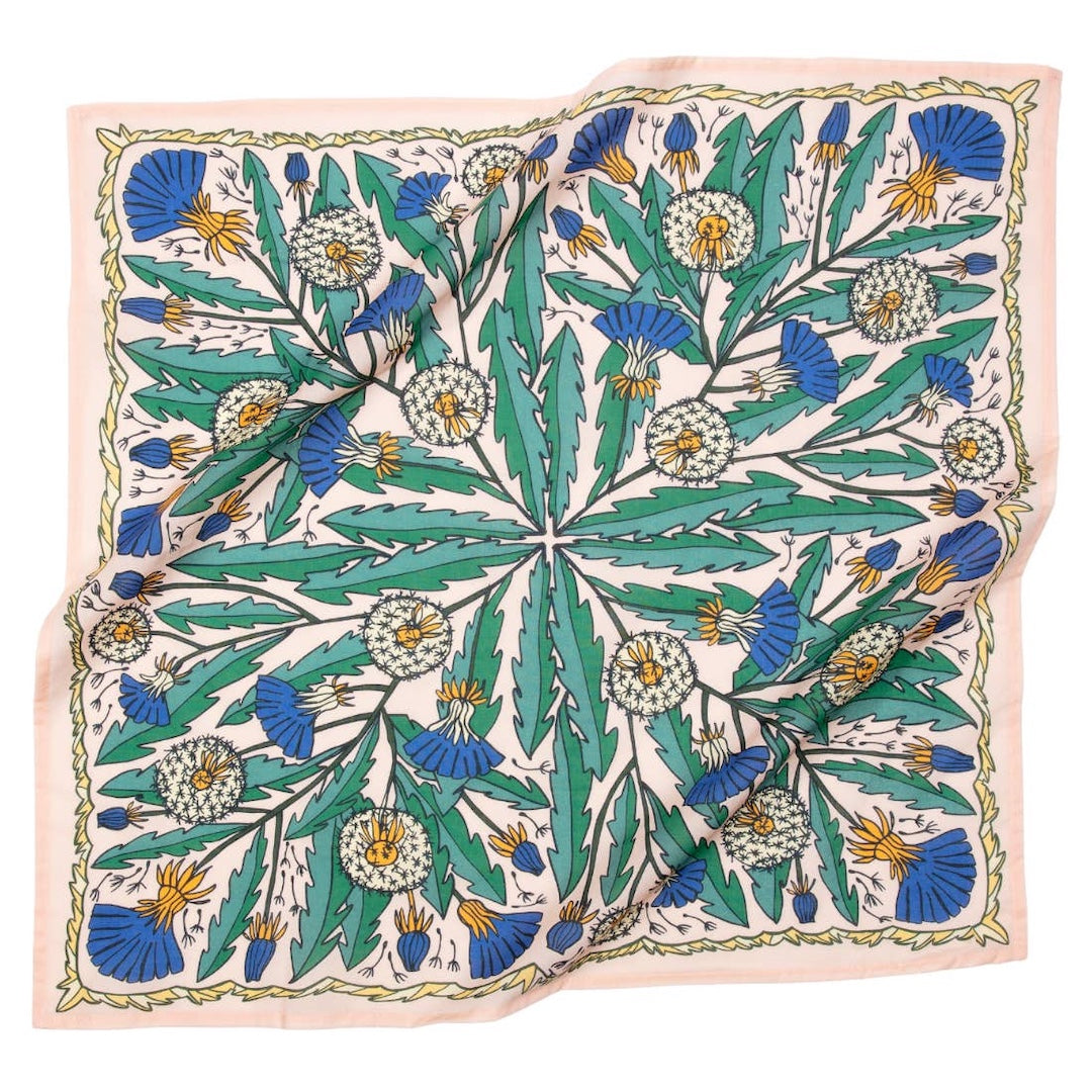 Light pink bandana with dandelions and other flowers on it