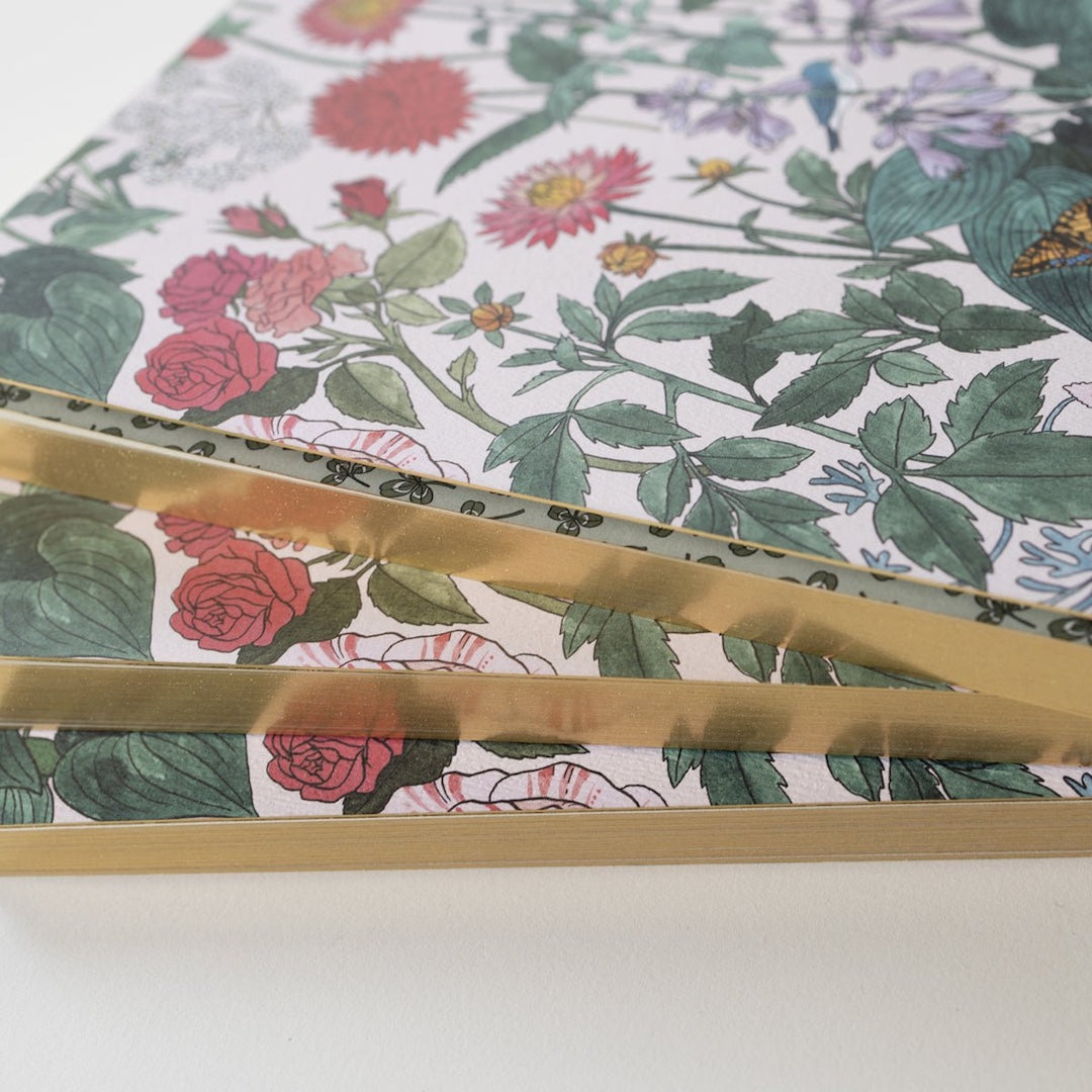 A stack of 3 notebooks highlighting that the pages have gold edges
