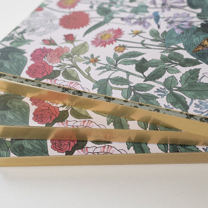 A stack of 3 notebooks highlighting that the pages have gold edges