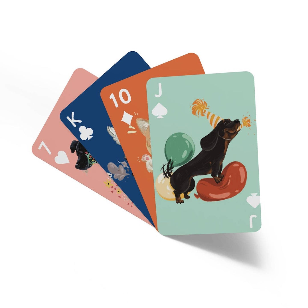 Set of playing cards with dog illustrations on a white background