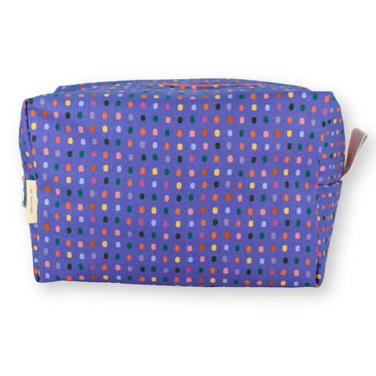 A rectangular zippered pouch with a purple background covered in a dense pattern of small multicolored dots, shown on a plain white background.