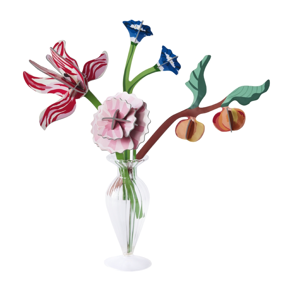Colorful floral arrangement in glass vase on a white background